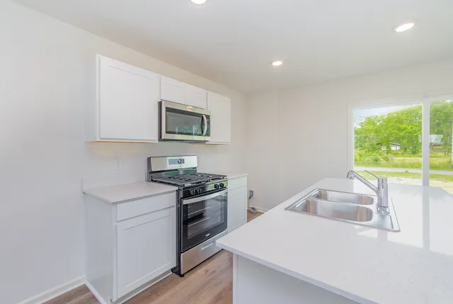 a kitchen that has a sink and a stove
