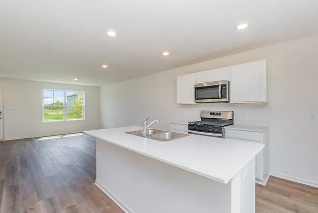 a kitchen with a sink appliances and cabinets