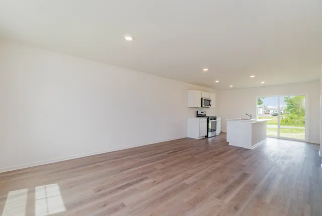 a view of a kitchen with wooden floor