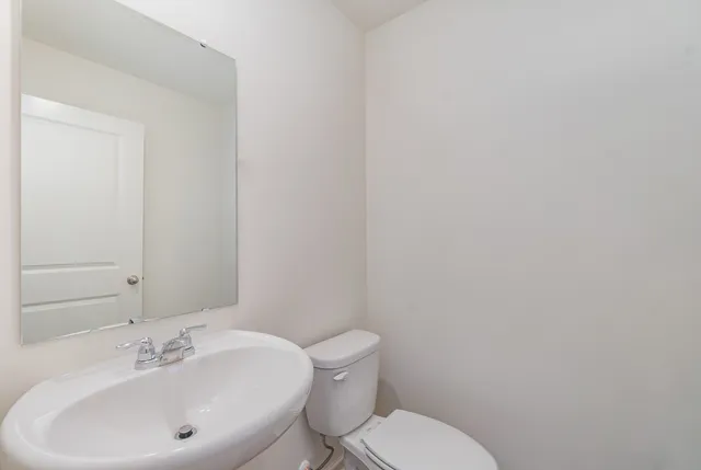 a white toilet sitting next to a white sink