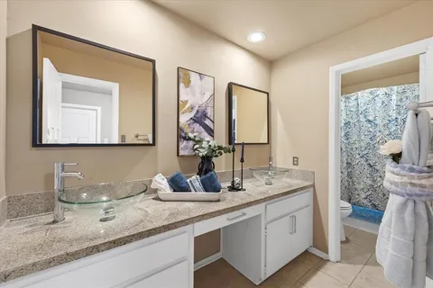 a bathroom with double vanity sinks and a mirror