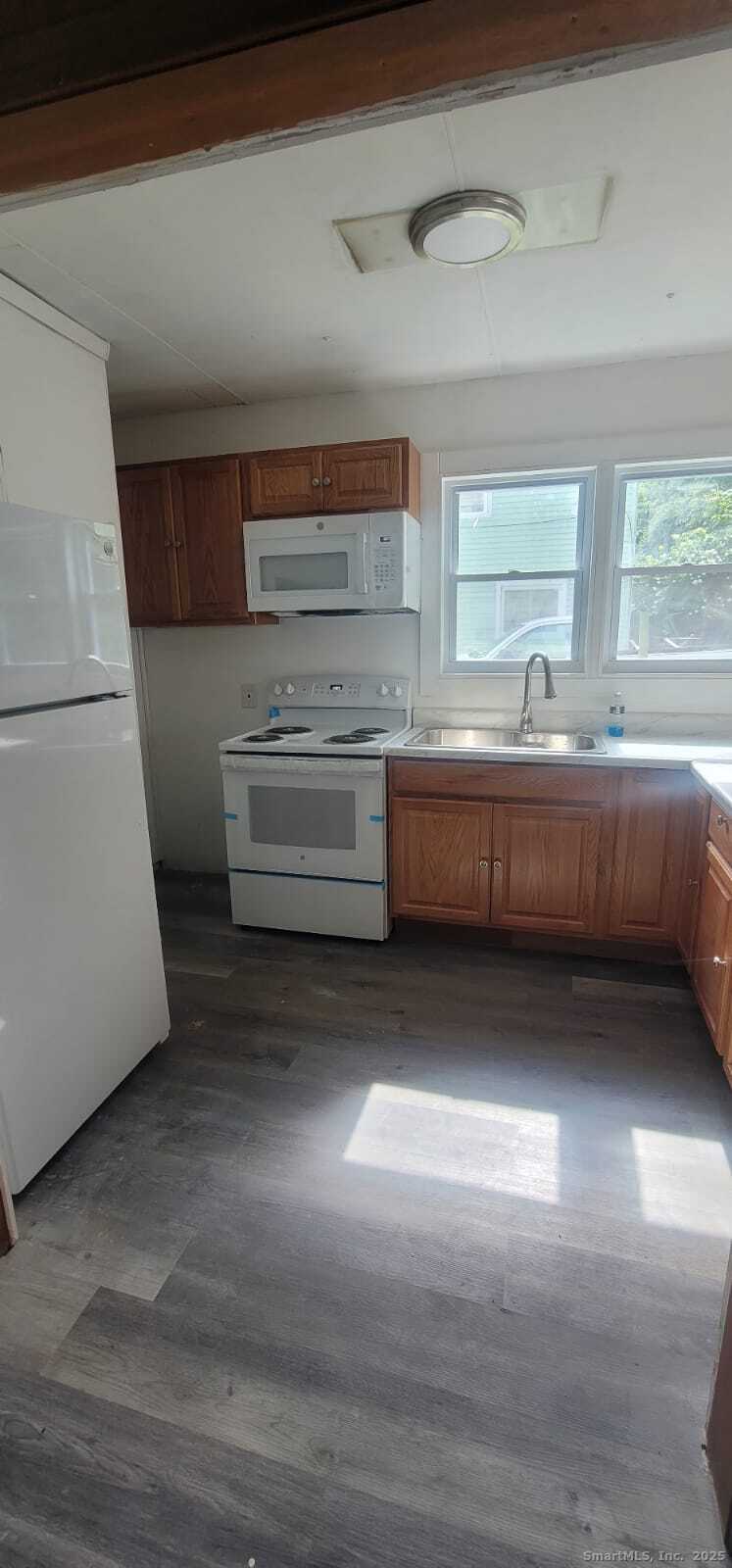 183 High Street Sprague, CT 06330 - Photo 7 of 10 a kitchen with kitchen island sink granite counter tops and a window