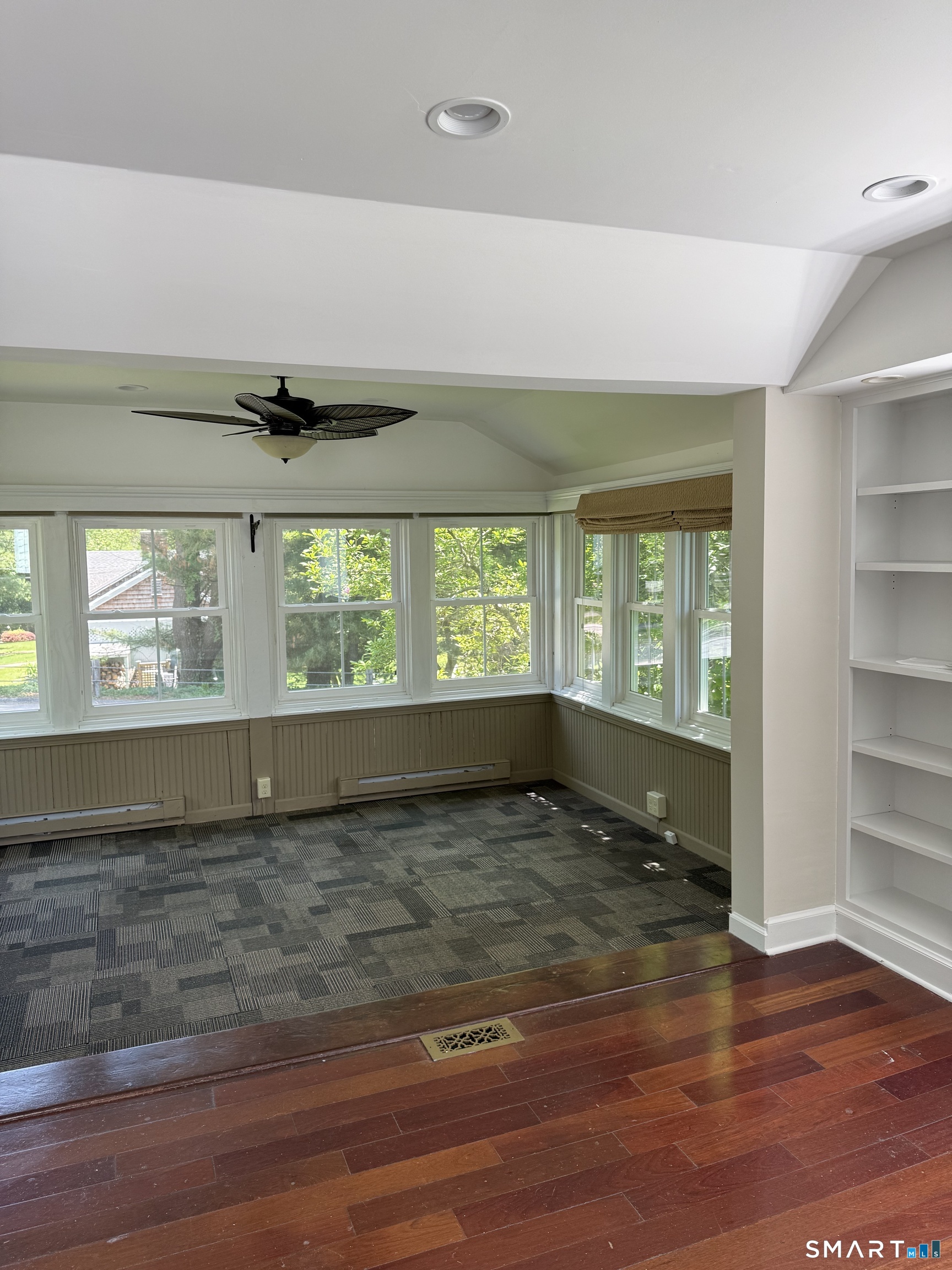 312 Ferry Road Old Lyme, CT 06371 - Photo 5 of 16 a view of an empty room with a window and wooden floor