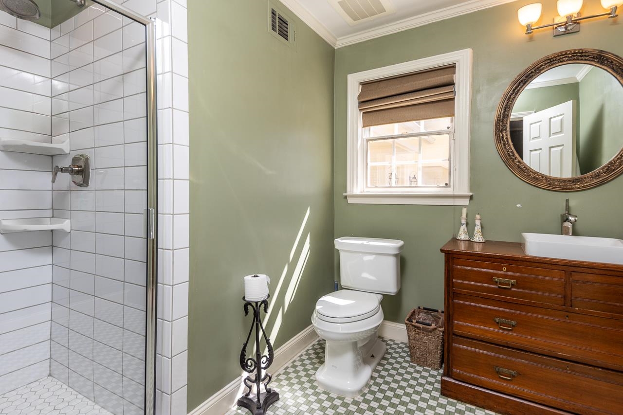 4723 Gwynne Road Memphis, TN 38117 - Photo 20 of 40 a bathroom with a toilet a sink and a mirror