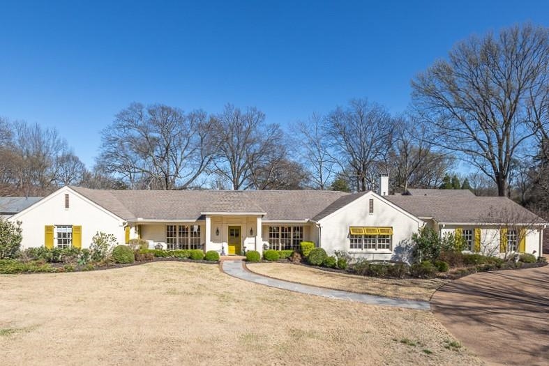 4723 Gwynne Road Memphis, TN 38117 - Photo 2 of 40 a front view of a house with a yard and garage