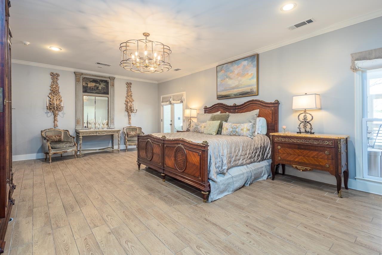 4723 Gwynne Road Memphis, TN 38117 - Photo 24 of 40 a bedroom with bed and a chandelier