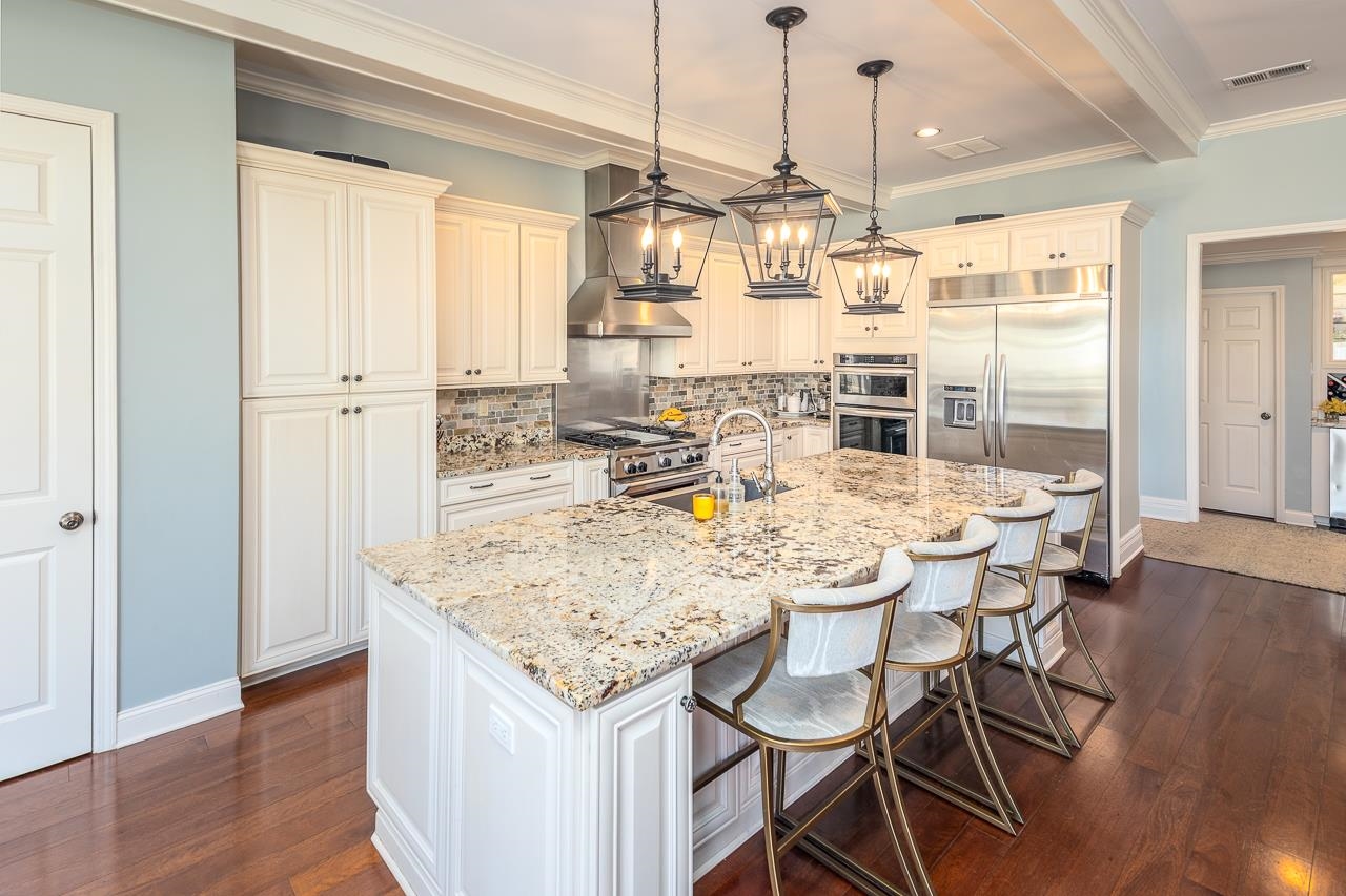 4723 Gwynne Road Memphis, TN 38117 - Photo 8 of 40 a dining table with chairs and wooden floor