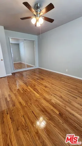 a view of an empty room and chandelier fan