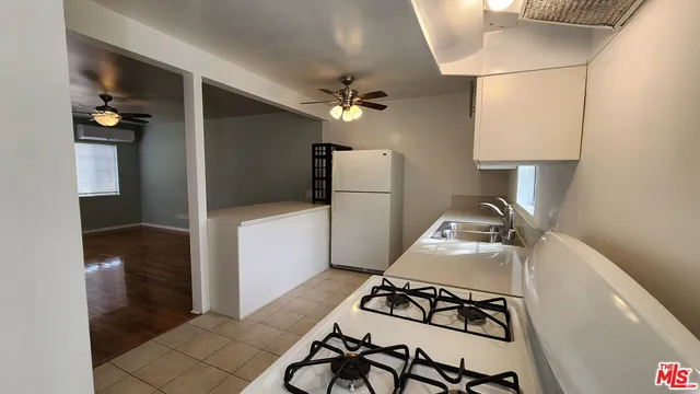 a kitchen with a sink a stove and a refrigerator
