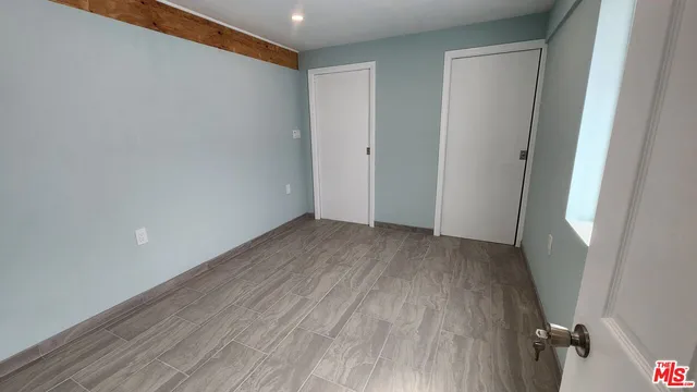 a view of a room with wooden floor and closet