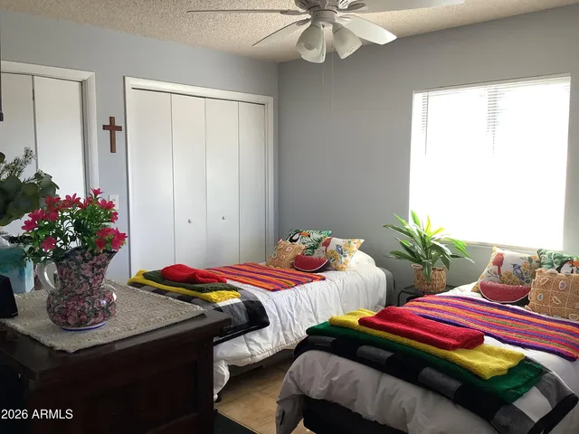 a bathroom with a granite countertop toilet sink and mirror