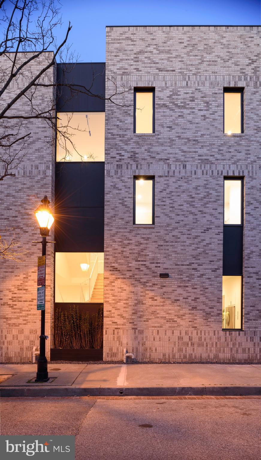 a brick building with a view of front door