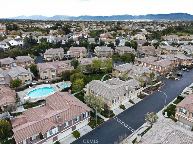 an aerial view of a houses with a city view