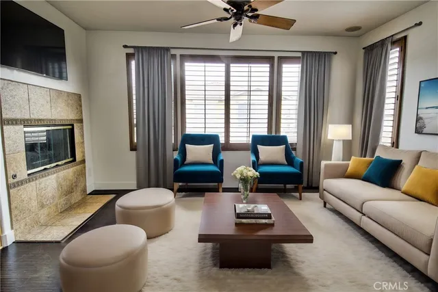 a living room with furniture a flat screen tv and a large window