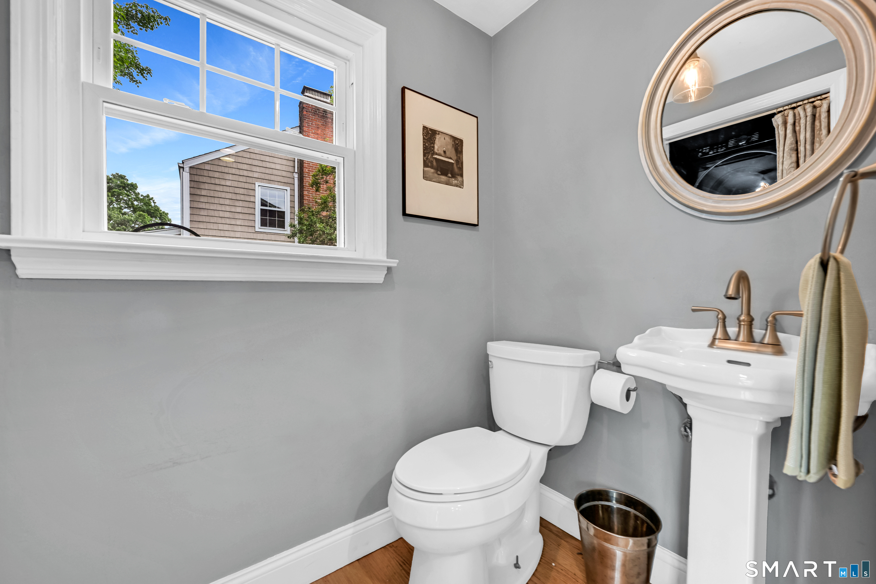 47 Spring Lane West Hartford, CT 06107 - Photo 24 of 38 a bathroom with a toilet a sink and a mirror