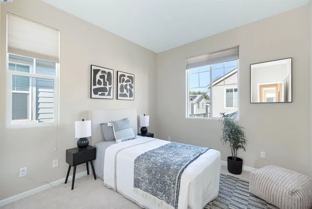 a bedroom with a large bed and a window