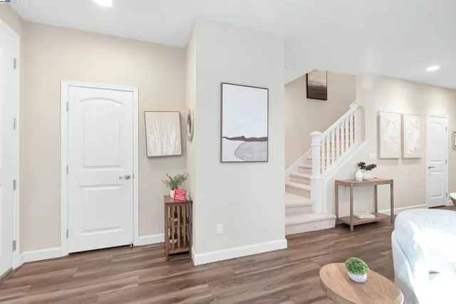 a hallway with wooden floor and furniture