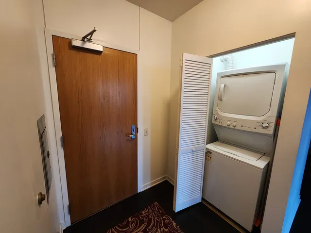 a view of a storage & utility room with a refrigerator