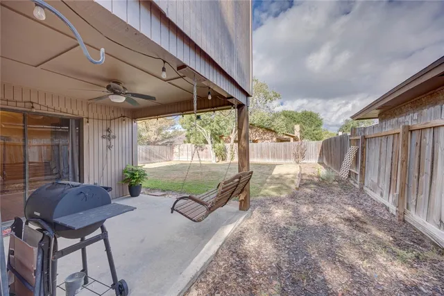 a view of a porch with furniture and a yard