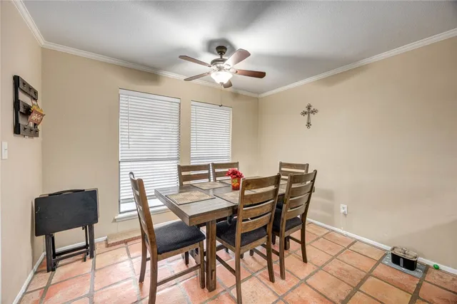 a view of a dining room with furniture and a chandelier fan