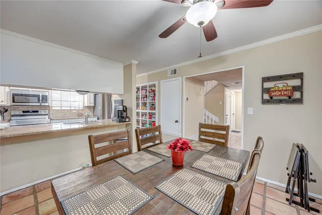 a living room with furniture and a kitchen area