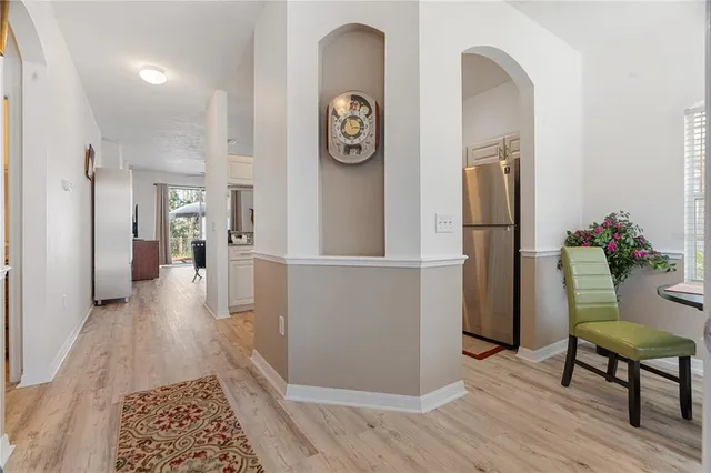 a view of a kitchen with a sink and refrigerator