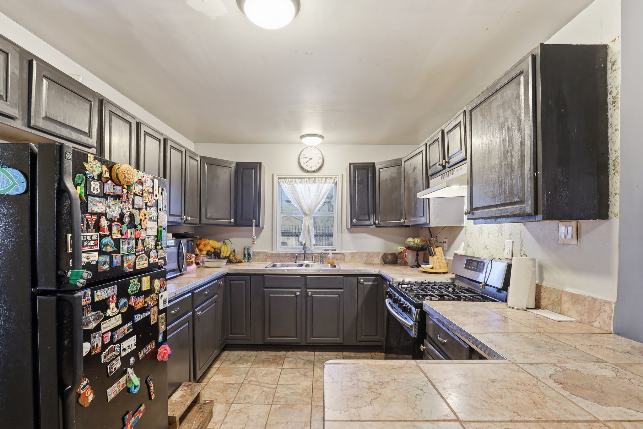 829 Becker Street Channelview, TX 77530 - Photo 5 of 19 a kitchen with stainless steel appliances a sink dishwasher stove refrigerator and cabinets