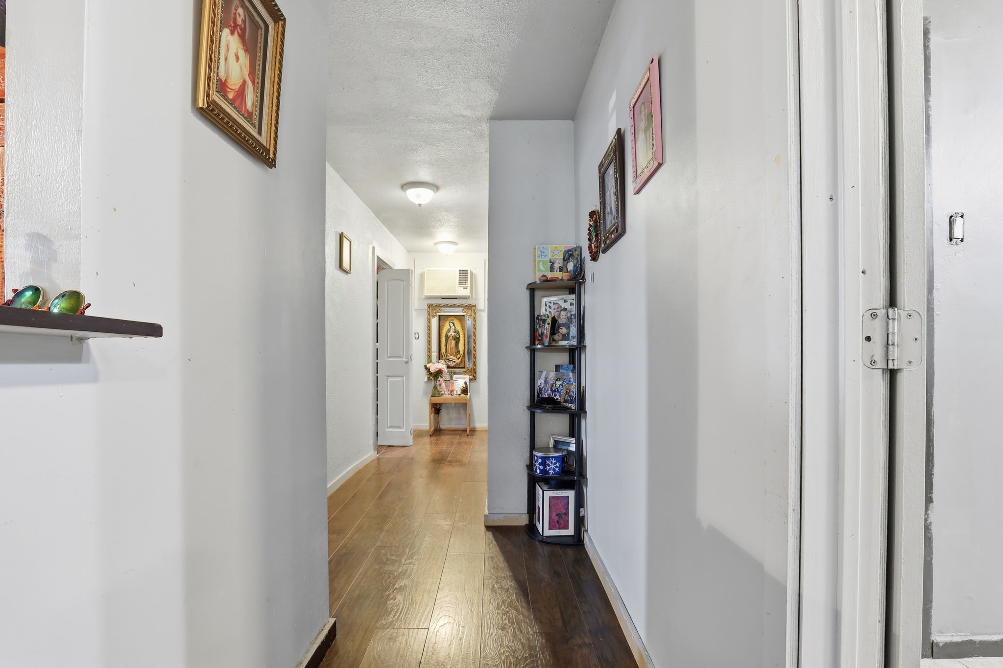 829 Becker Street Channelview, TX 77530 - Photo 7 of 19 a view of a hallway with wooden floor and closet