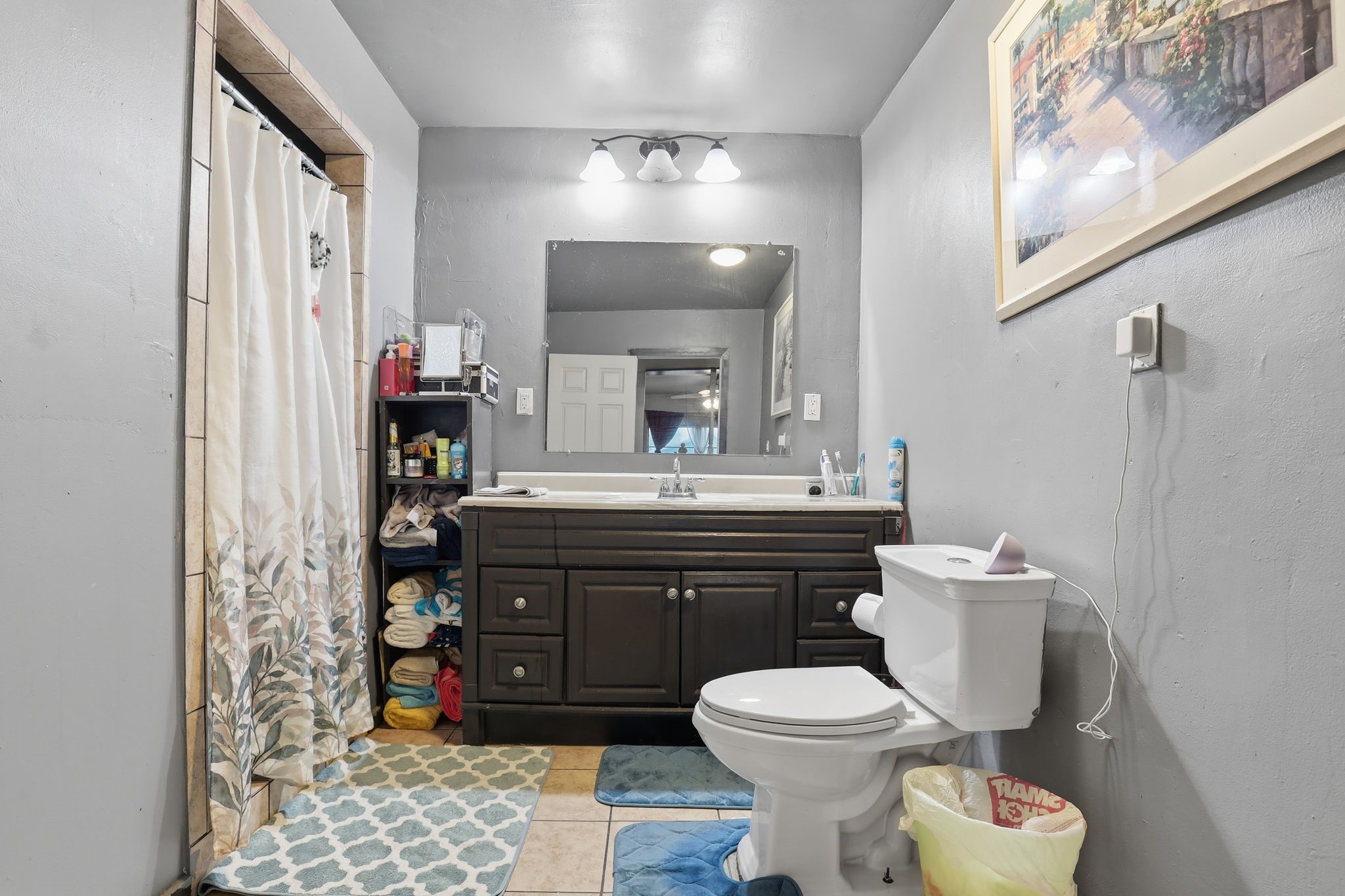 829 Becker Street Channelview, TX 77530 - Photo 8 of 19 a bathroom with a toilet a sink and a mirror