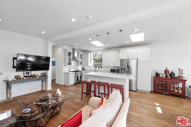 a living room with furniture a fireplace and a table