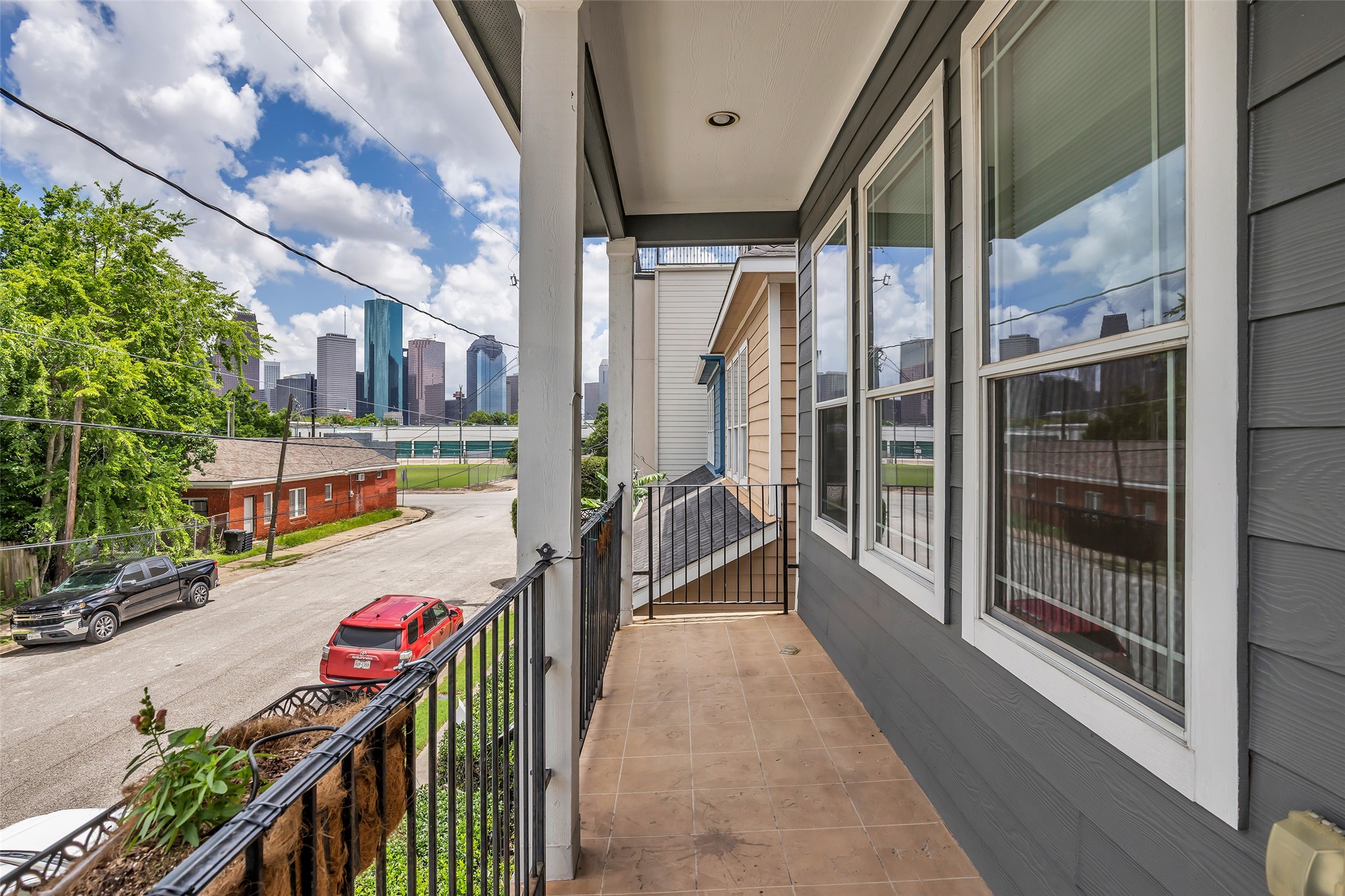 1423 Colorado Street Houston, TX 77007 - Photo 20 of 28 View from the second-floor balcony overlooks the street and surrounding neighborhood, offering an open outlook and a sense of the area’s setting.