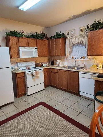 a kitchen with a stove a sink and a refrigerator