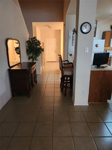 a dining room with furniture and a window