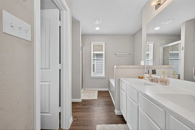 a bathroom with double vanity and mirrors