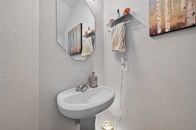 a bathroom with a sink and mirror