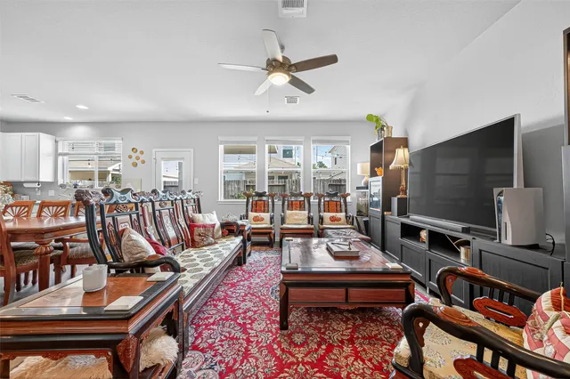 a living room with furniture a rug and a flat screen tv