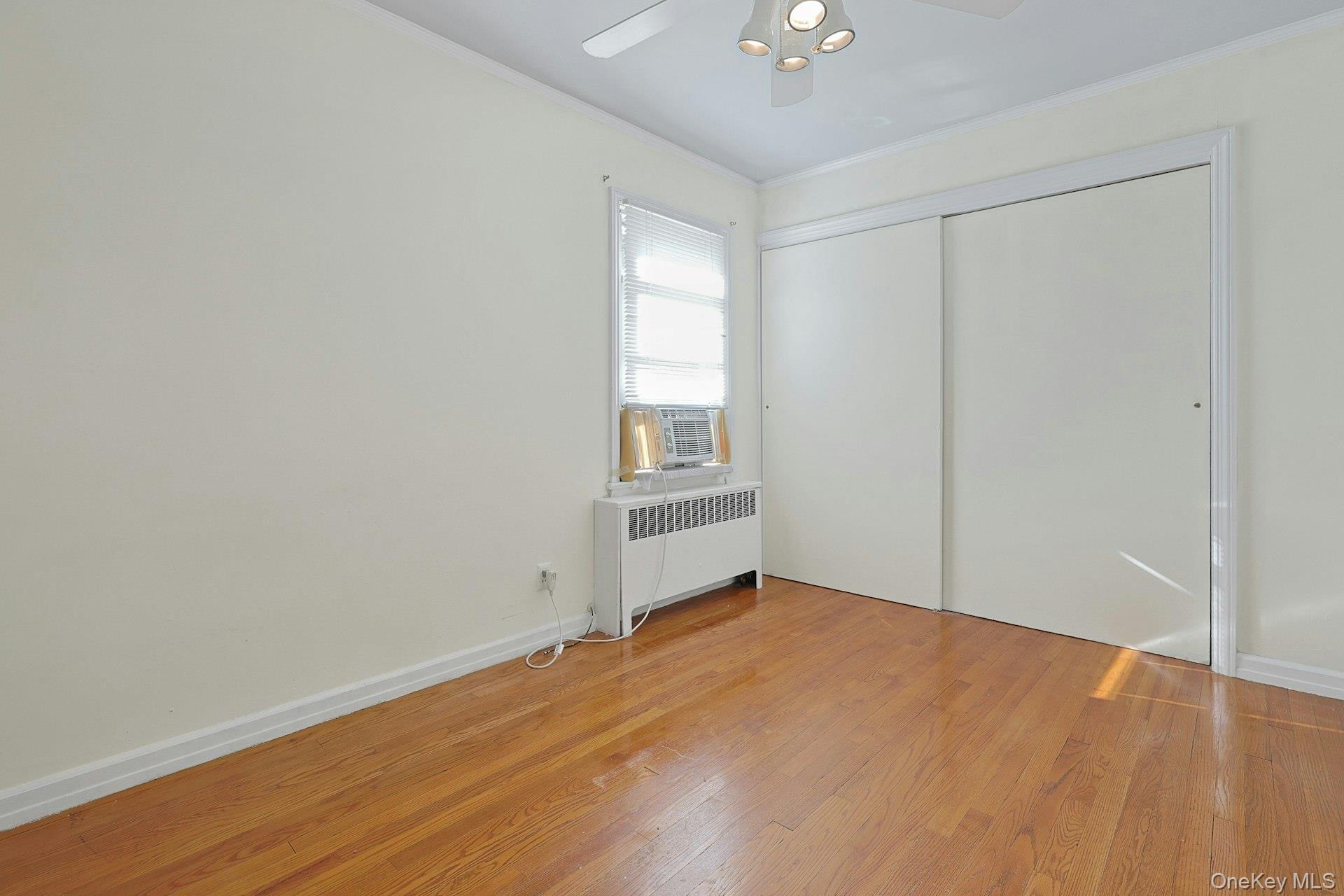 86 Braunsdorf Road Pearl River, NY 10965 - Photo 18 of 38 a view of an empty room with wooden floor and a window