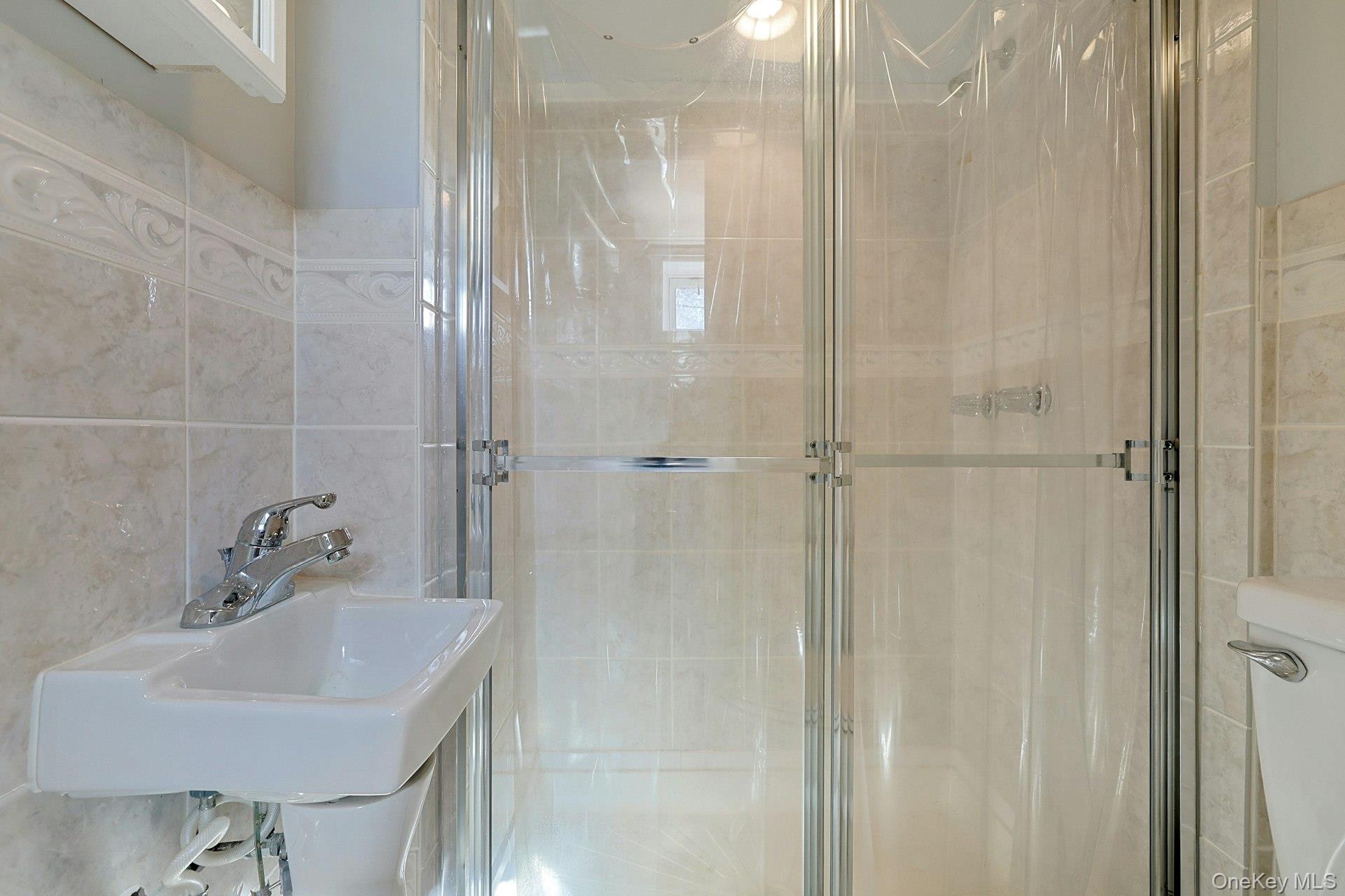 86 Braunsdorf Road Pearl River, NY 10965 - Photo 31 of 38 a bathroom with a sink shower and a mirror