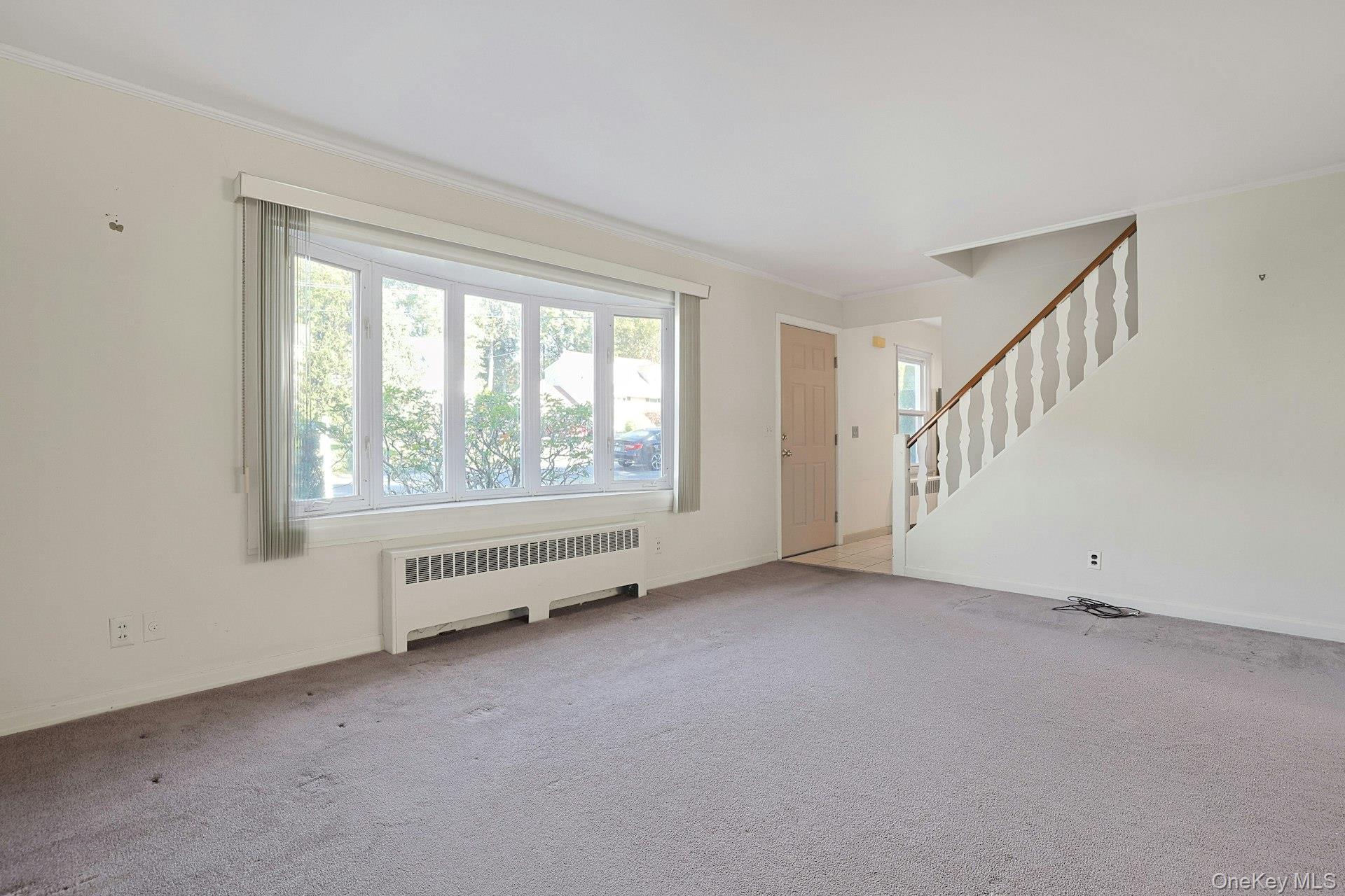 86 Braunsdorf Road Pearl River, NY 10965 - Photo 5 of 38 a view of an empty room with wooden floor and windows