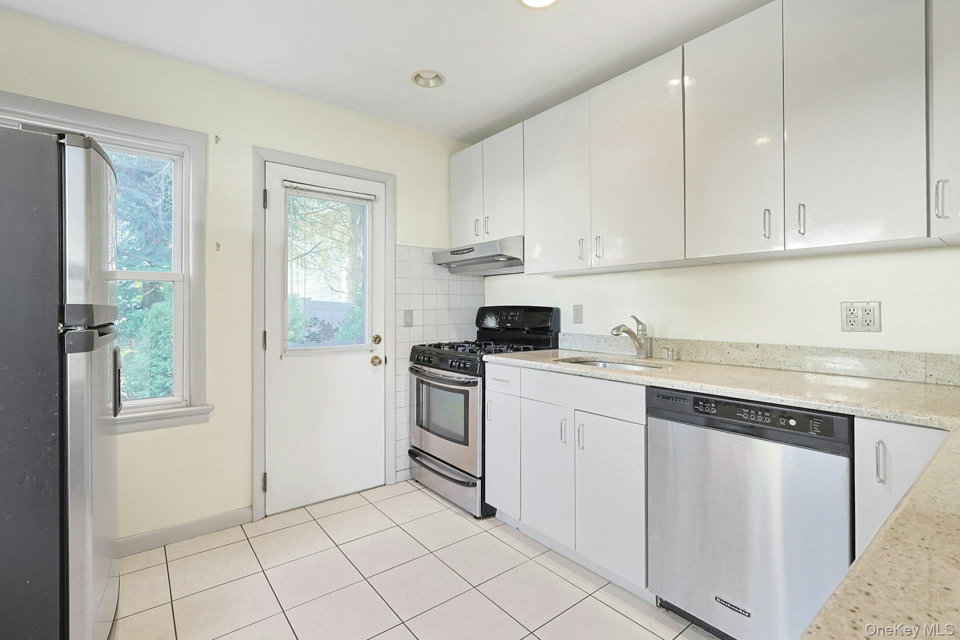 86 Braunsdorf Road Pearl River, NY 10965 - Photo 10 of 38 a kitchen with white cabinets and white appliances