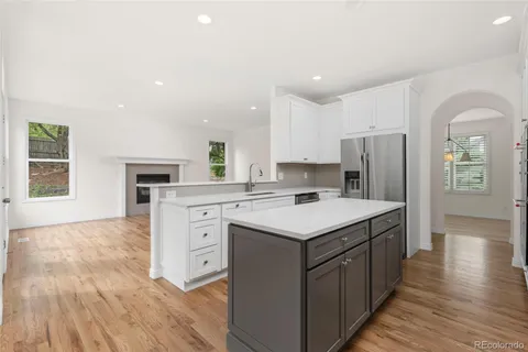 a kitchen with a sink a refrigerator and a stove