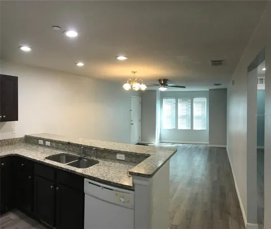 a kitchen that has a sink stove and cabinets
