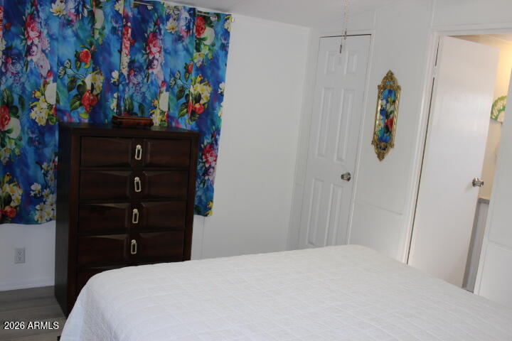 9501 East Broadway Road, Unit 101 Mesa, AZ 85208 - Photo 13 of 24 a bedroom with a bed and a dresser