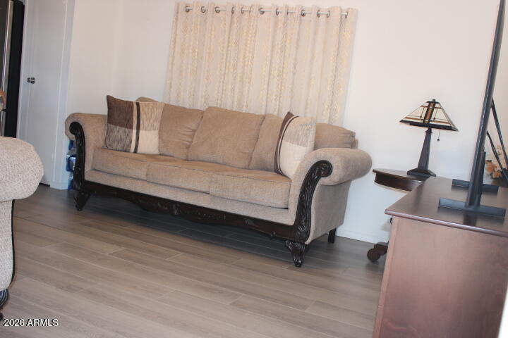 9501 East Broadway Road, Unit 101 Mesa, AZ 85208 - Photo 3 of 24 a living room with furniture and a wooden floor