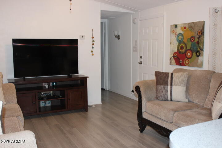 9501 East Broadway Road, Unit 101 Mesa, AZ 85208 - Photo 4 of 24 a living room with furniture and a flat screen tv