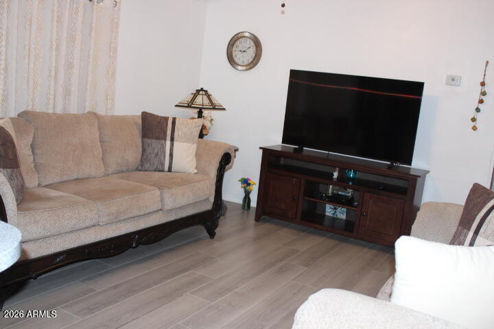 9501 East Broadway Road, Unit 101 Mesa, AZ 85208 - Photo 5 of 24 a living room with furniture and a flat screen tv