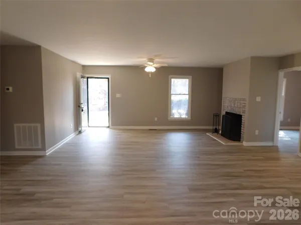 a view of a livingroom with wooden floor and window