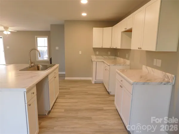 a kitchen with a sink stove and cabinets
