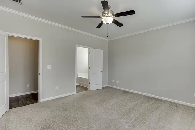 en empty room with ceiling fan and window