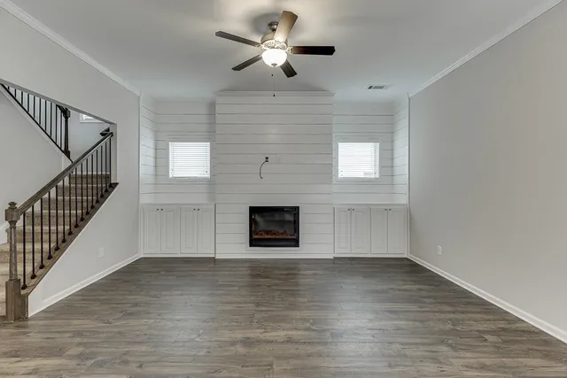 a view of an empty room with a fireplace and a window